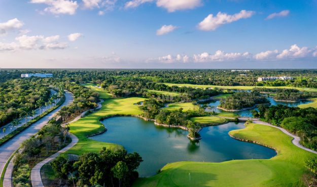 Arial view of PGA Riviera Maya Golf Course featuring fairways, greens, bunkers, and water features